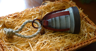 Rustic bell with red metal ribbon