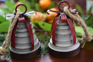 Rustic bell with red metal ribbon