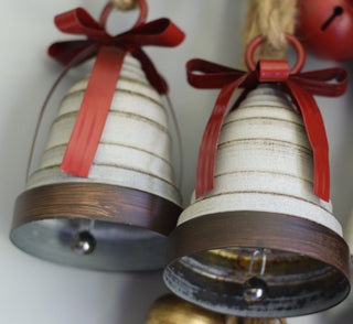 Rustic bell with red metal ribbon